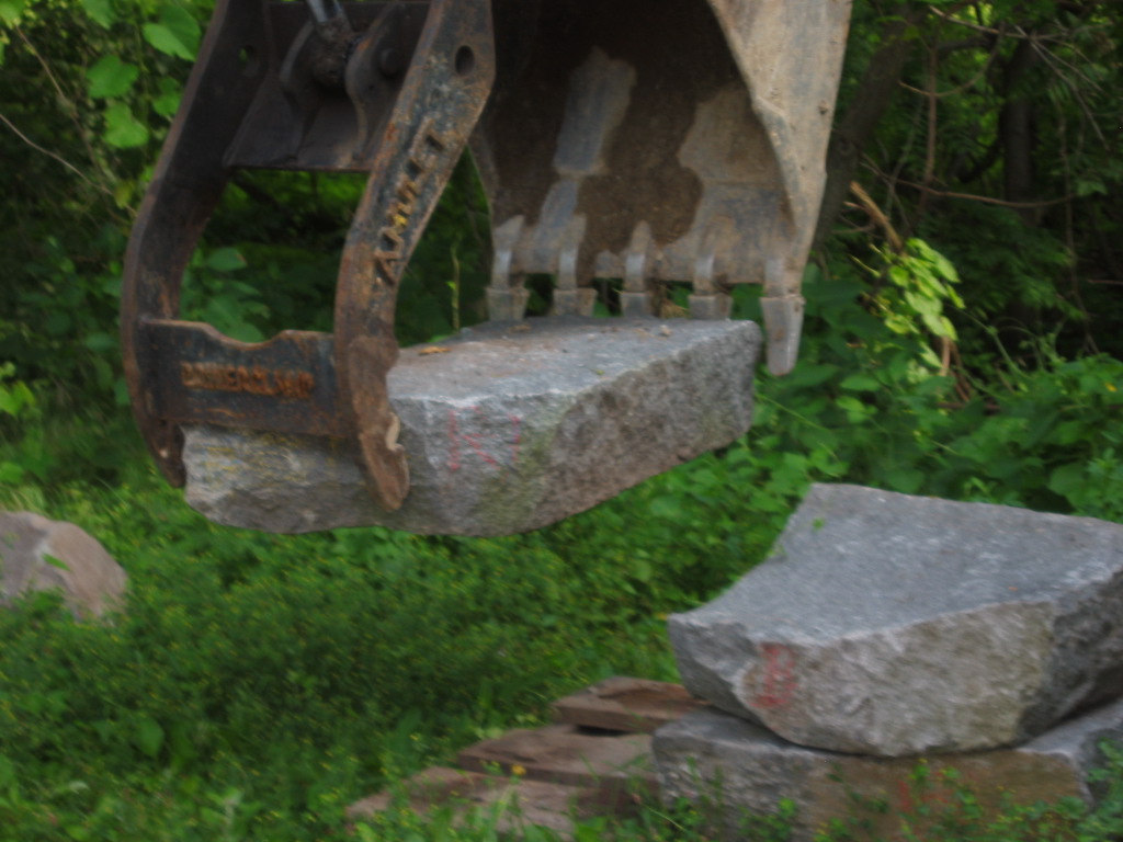 0030: Grappling granite bed-stone into position supporting sandstone landin