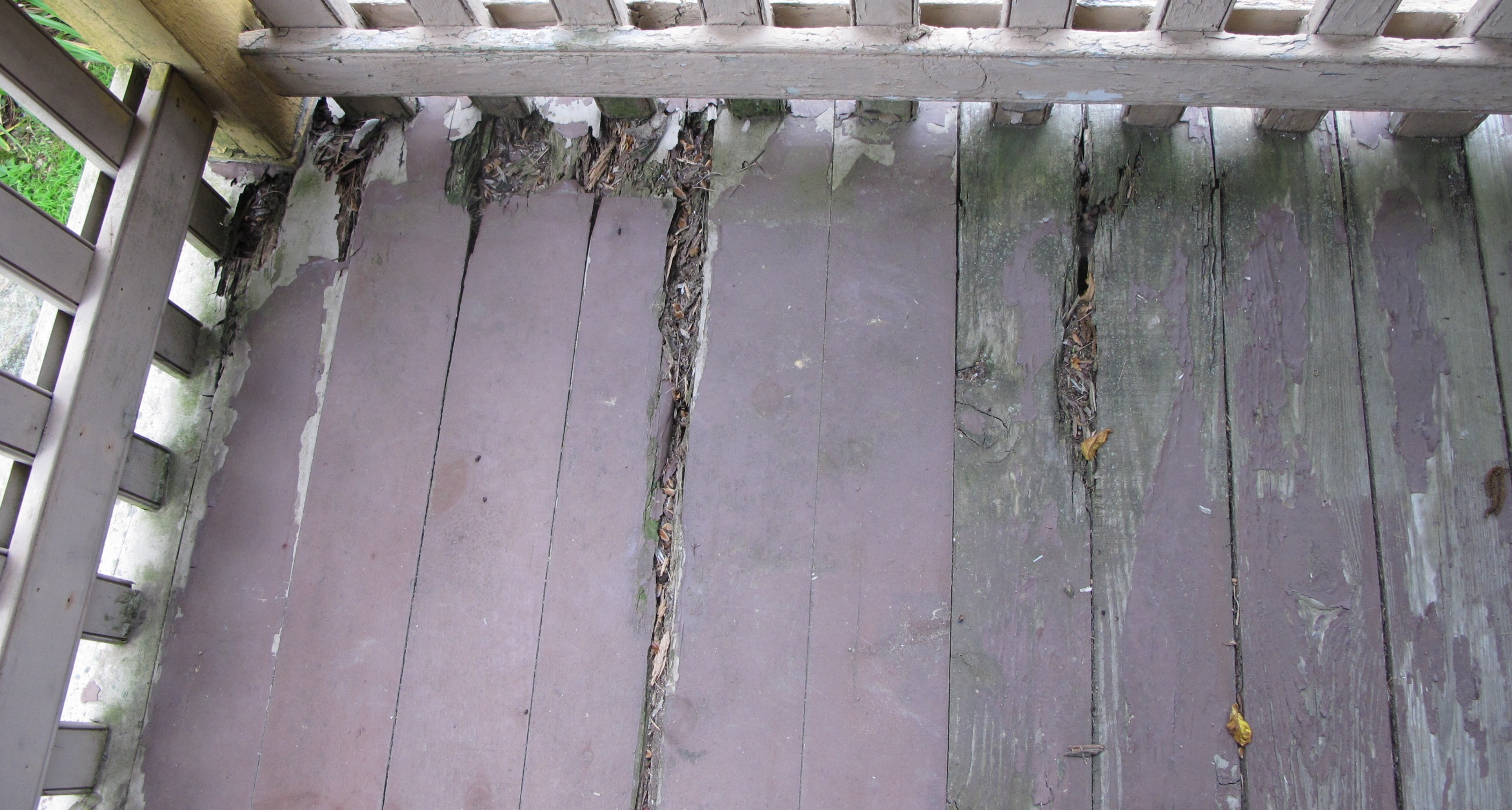 #15, 4174: deteriorated floor boards of 1930s porch