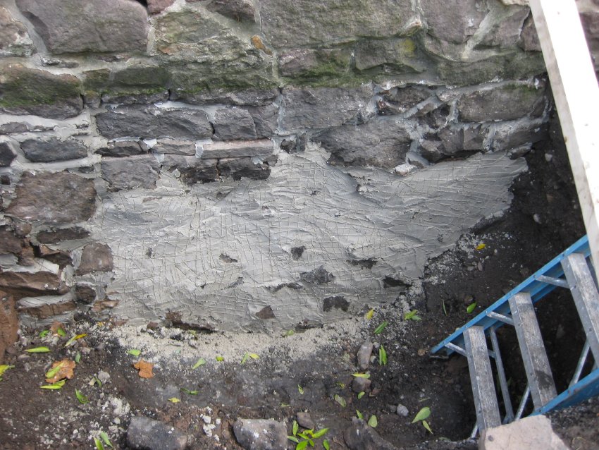 [#1158, 10/7/10]: Scratch-coat pargeting on W segment of N gable foundation