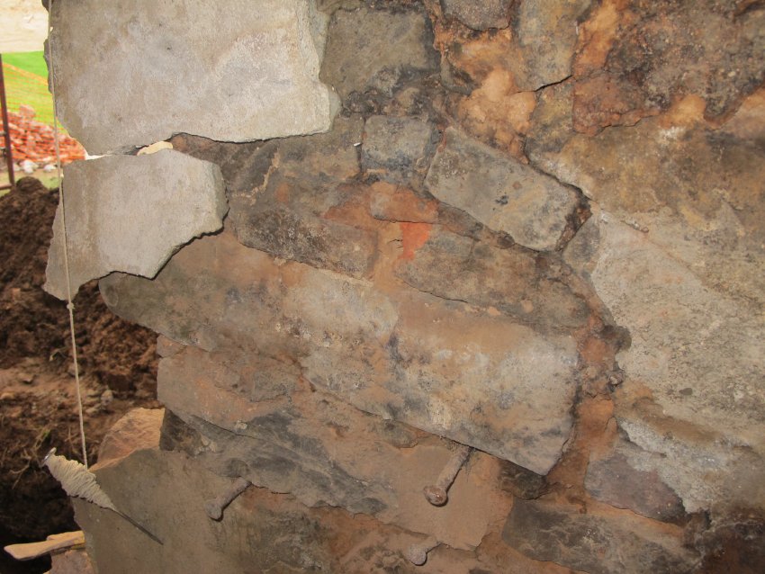 Image #8: 6318: Charred stones in fireplace wall at site of "squirrel tail"