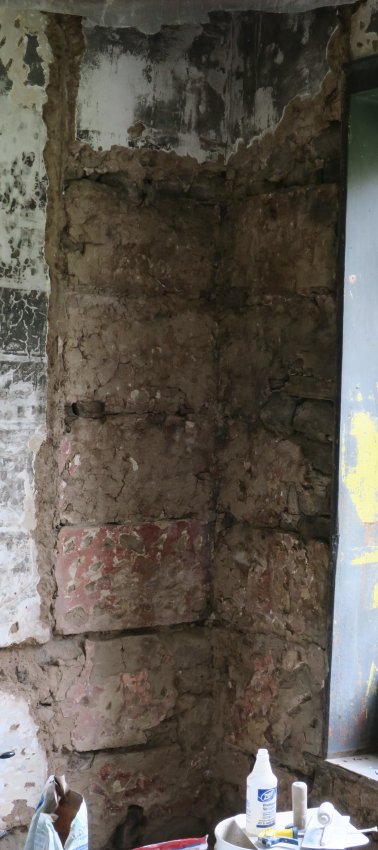 Image #9: stone back-walls of corner cupboard, red-paint residue