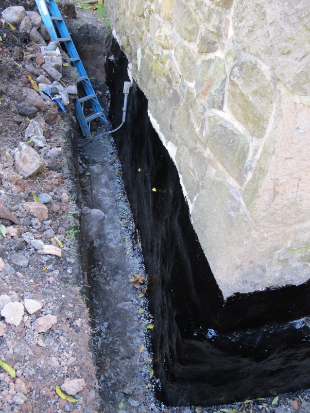 Photo 106: Foundation corner with black impervious coating membrane