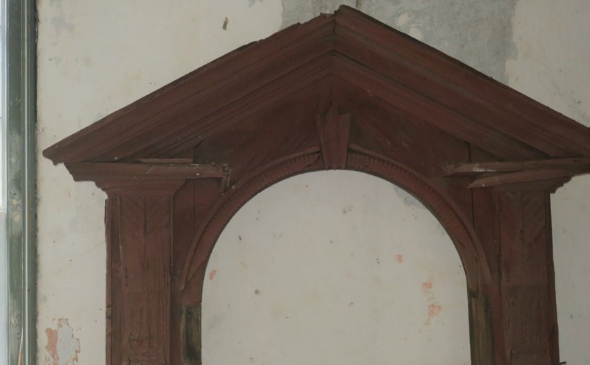 Detail of upper frame and pediment, showing ornate vernacular joinery